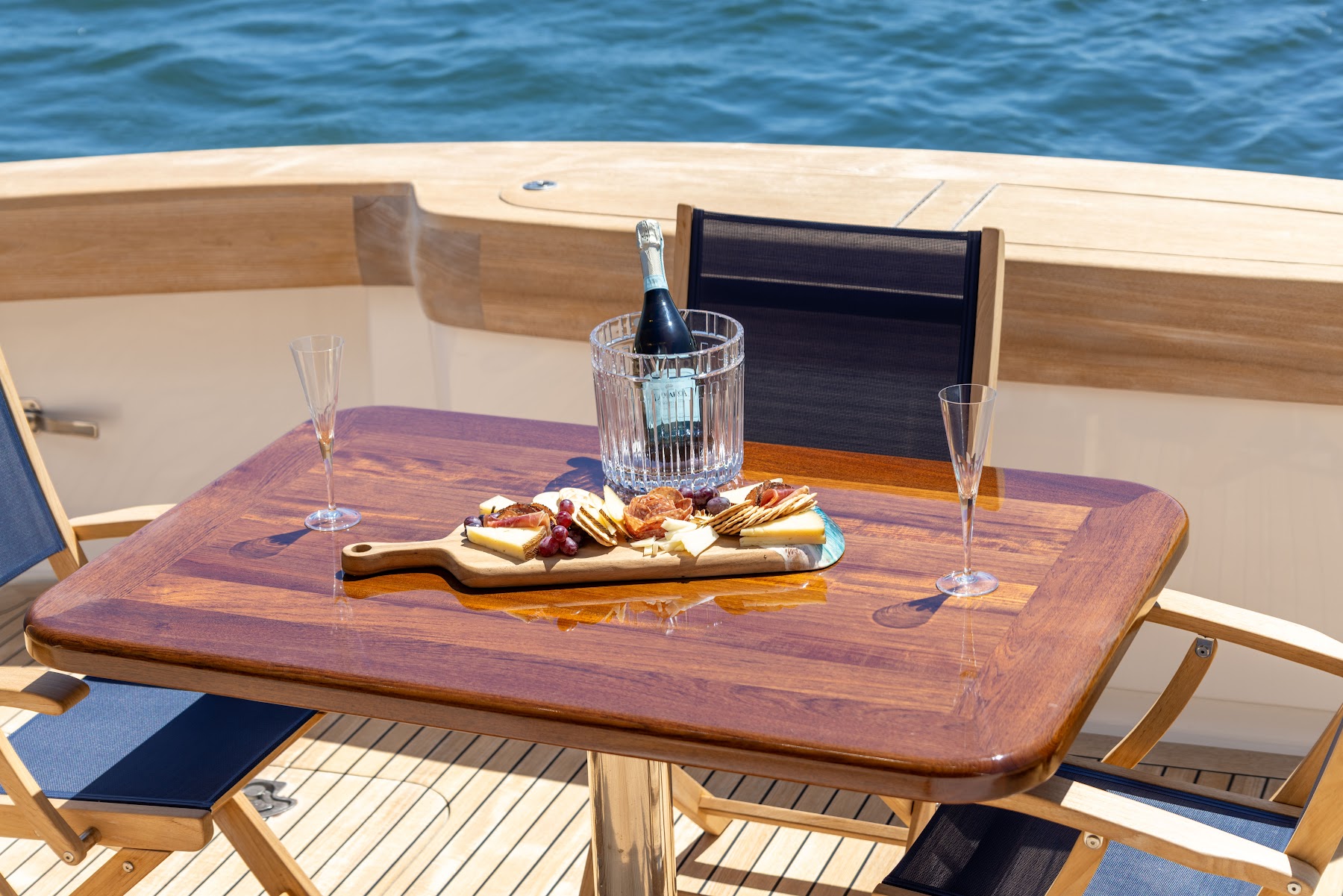 Lifestyle photography of champagne and charcuterie on a polished wood table
